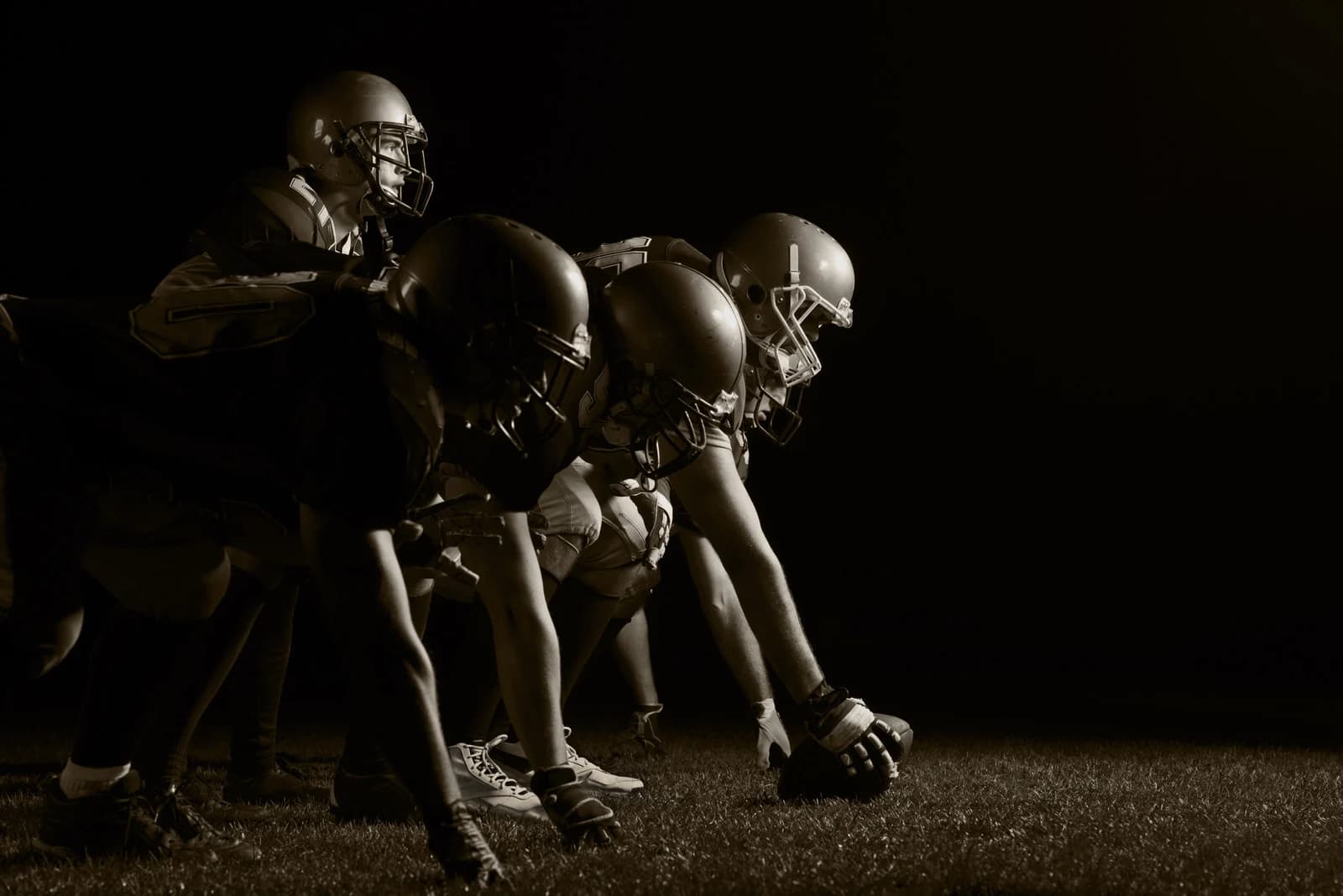 Football players at the line of scrimmage